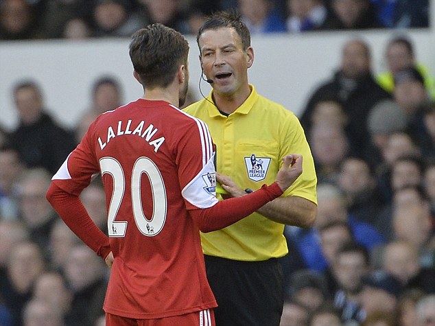 Southampton's Adam Lallana is spoken to by referee Mr Mark Clattenburg before being shown a yellow card